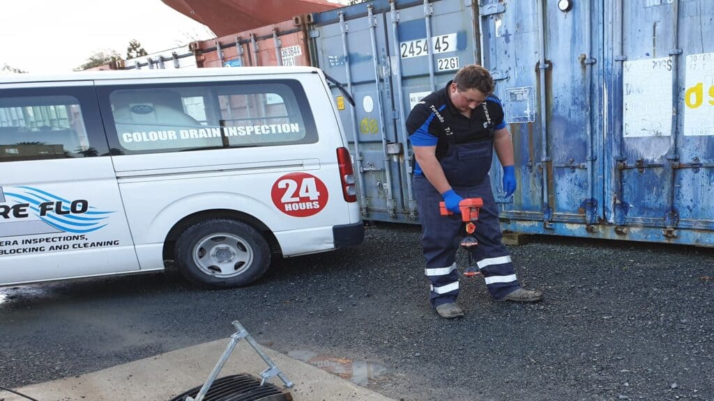 Technician inspecting a shipping container for colour and structural issues.